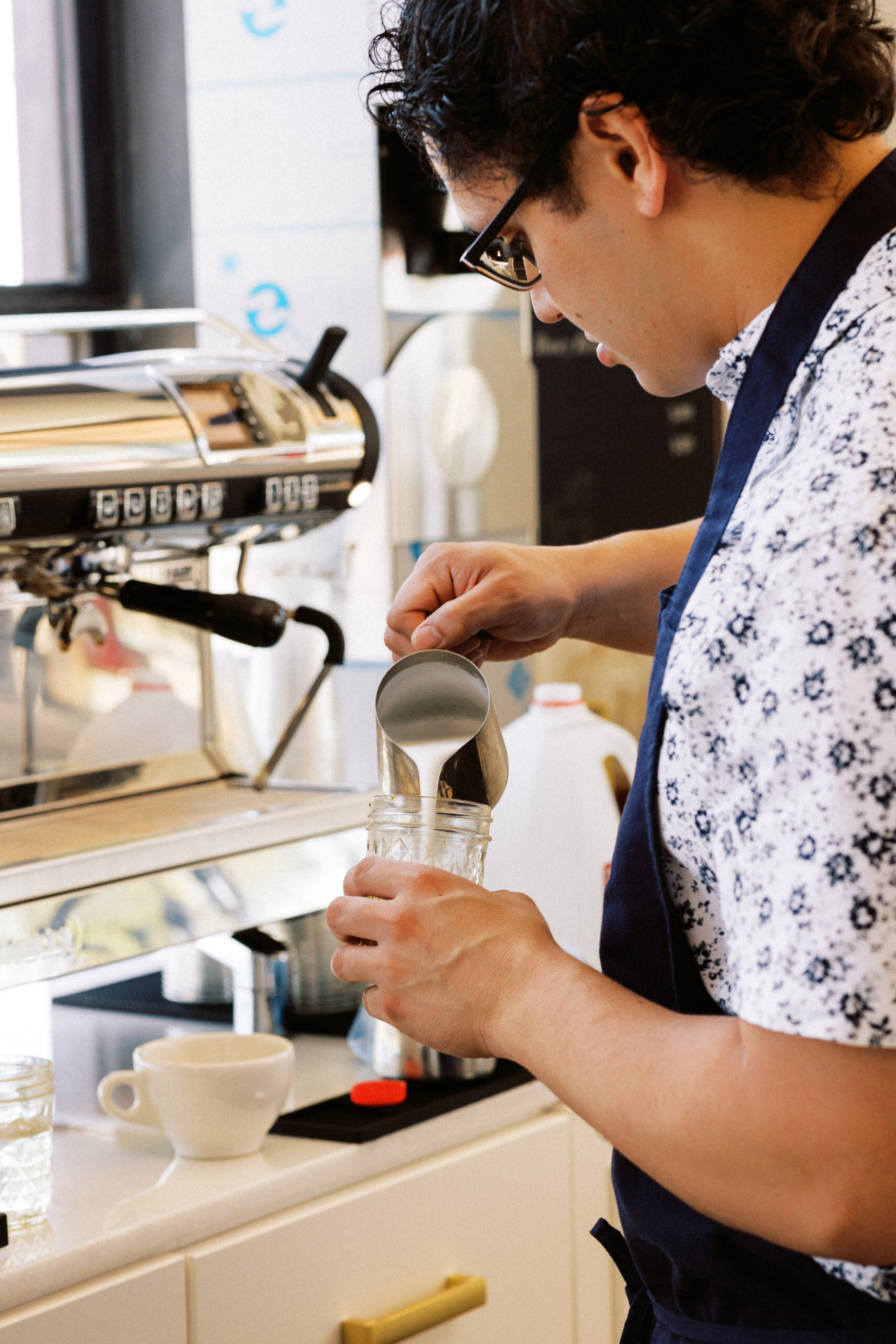 Avenue Brew barista crafting an artisan espresso drink