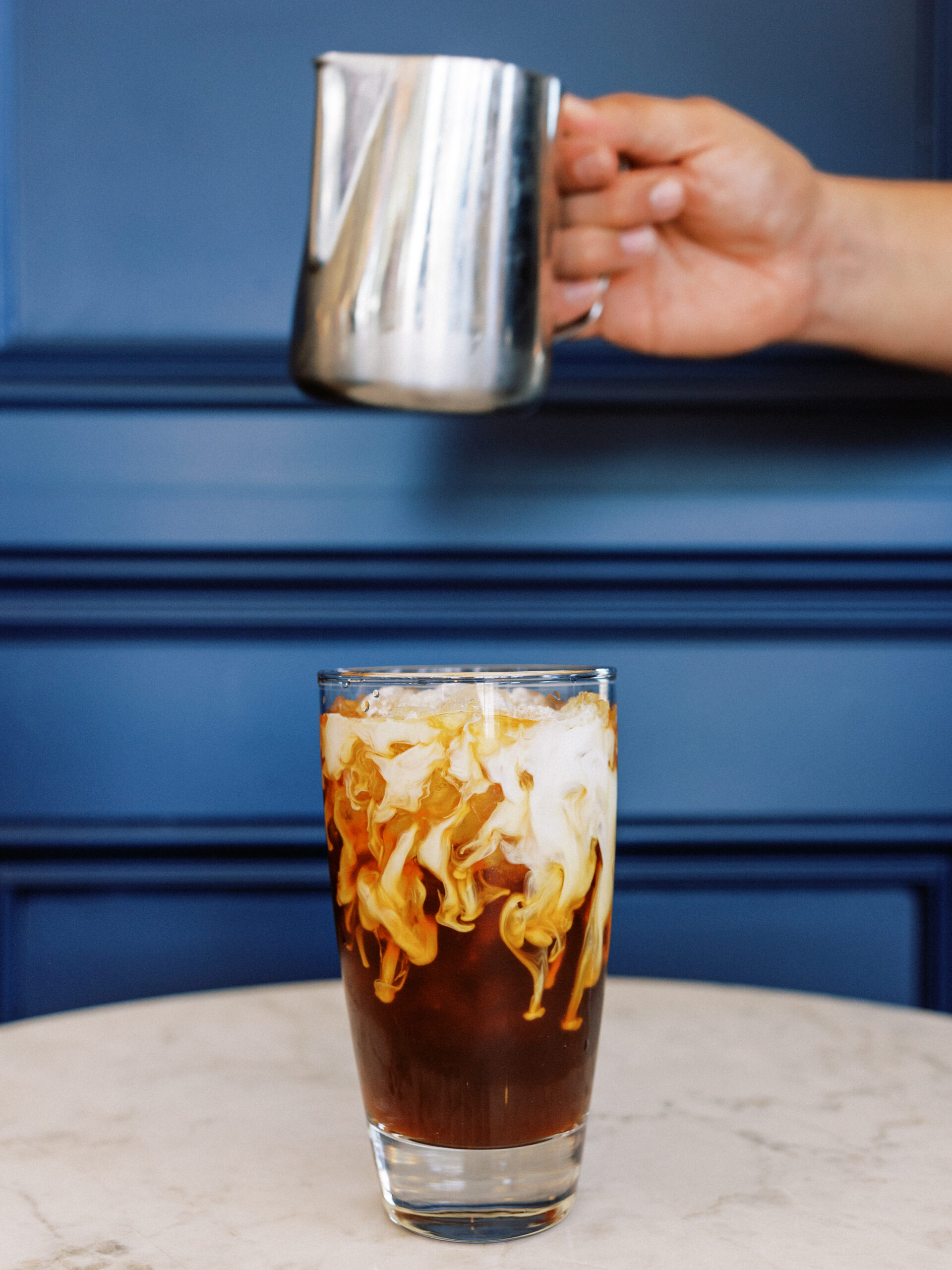 Avenue Brew espresso drinks lined up on marble counter